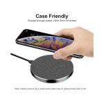 A round, grey tweed wireless charger with a smartphone on top, featuring a subtle branding logo.