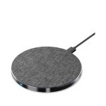 A round, grey wireless charger with a textured surface and a connecting cable. It features a small indicator light.