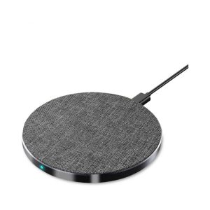 A round, grey wireless charger with a textured surface and a connecting cable. It features a small indicator light.