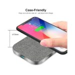 A square wireless charger with a grey fabric finish, designed to charge phones while in their case.