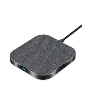 A square wireless charger in grey fabric with a black base, featuring a charging cable attached.