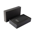 A black wireless power bank with a sleek design, presented in a matching black box with a cushioned interior.