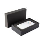 A white power bank with a logo, presented in a black gift box with foam padding.