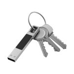 A silver LED flash drive attached to a keyring with several keys. The flash drive has a sleek design.