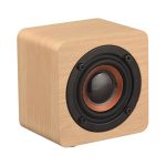 A wooden square speaker with a black circular speaker grill and copper detail, featuring a logo on its side.