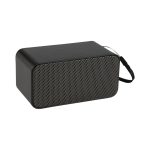 A black wireless charging speaker with a mesh front and a carrying strap. It features a logo on the side.