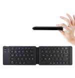 A foldable Bluetooth keyboard in black, being held in a hand, featuring a compact design with illuminated keys.