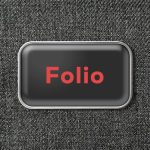 A black toiletry bag with a silver trim and a logo featuring the word "Folio" in red.