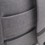A grey backpack featuring multiple pockets and a sleek design, with a logo on the surface.