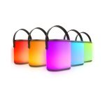 A set of five portable LED speakers in various colours, featuring soft glow effects and carrying handles.