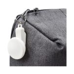 A grey bag with a white keyring attachment prominently displayed on the zipper.
