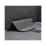 A black fabric laptop bag with a structured design and a Velcro closure. It features a textured surface.
