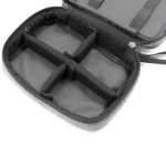 A grey toiletry bag featuring multiple compartments, with a zippered closure and an interior lining.