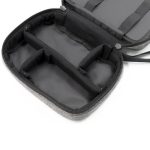 A grey toiletry bag with a zippered closure, featuring multiple inner compartments and a sleek black interior.