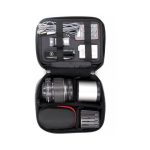 A black accessory case filled with a camera lens, battery packs, cables, a multi-tool, and a memory card.