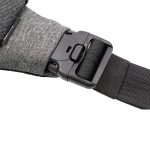 A grey fabric strap featuring a secure buckle and adjustable black webbing. The image displays part of a sling bag.