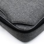 A grey laptop bag featuring a textured fabric and a zip closure. It includes a branding logo.