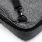A grey laptop bag with a zipper, featuring a clip and fabric texture. It has a logo on the surface.