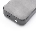 A grey wireless speaker with a smooth surface, featuring a port and a button. It has a minimalist design with a logo.