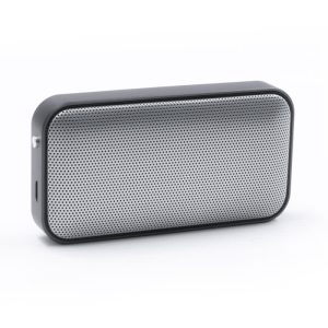A compact black and silver wireless speaker with a mesh front design and a side port. It features a logo on the surface.