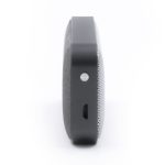 A side view of a black and grey Nano Vegan Wireless Speaker, featuring a sleek design and a small port.