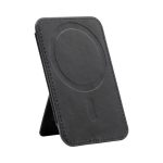 A black phone stand with a circular magnetised area and stitching details, featuring a logo on the surface.
