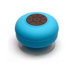 A round, blue waterproof Bluetooth speaker with a control panel on top, featuring a clear bottom.