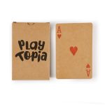 Recycled playing cards in a brown kraft box featuring a red heart Ace card. The box has a logo.