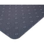 A dark grey desk mat features a textured pattern with small floral designs, showcasing rounded edges.