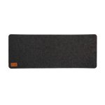 A dark gray desk mat with a felt texture and a small leather label in one corner.