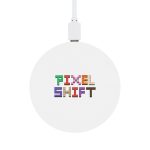 A round wireless charger featuring a white surface with the text "PIXEL SHIFT" displayed in colorful, pixelated letters.