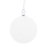 A round, white wireless charger with a textured surface and a connected charging cable.