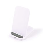 A white wireless charger with a sleek, angled design and a green accent at the base.
