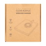A clear acrylic wireless charger in a cardboard box, featuring a circular charging pad and a Type-C power connection.