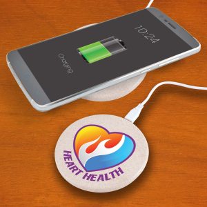 A round, beige wireless charger with a logo, supporting a smartphone displaying a charging battery icon.