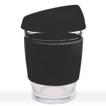 A reusable coffee cup with a transparent glass body and a black silicone lid and sleeve.