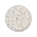 A round tin filled with small, round white mint candies.