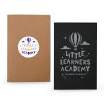 A pair of notebooks featuring a kraft cover and a black cover with a balloon design, both with branding.