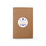 A brown notebook with a circular label featuring colourful text and a logo.