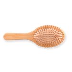 A bamboo hair brush featuring a smooth handle and evenly spaced bristles, designed for hair care.