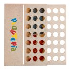 A beige game box featuring circular holes and colored pieces in red and blue, with a logo present.