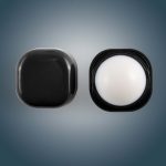 A Cube Lip Balm in a sleek black container, featuring a rounded lip balm interior.