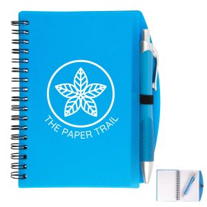A blue spiral notebook with a pen attached, featuring a logo on the cover and lined pages inside.