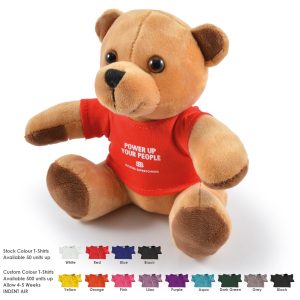 A fluffy tan teddy bear wearing a red T-shirt, sitting upright against a white background. Includes branding on the shirt.