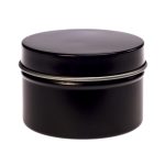 A petite black candle in a tin container with a smooth lid. The minimalist design features a sleek finish.