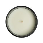 A medium Gleam Glass Candle featuring a smooth, white wax surface with a centered wick, contained in a sleek black jar.