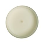 A medium-sized glass candle with a smooth, white wax surface and a single wick at the center.