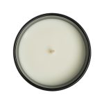A large glass candle in a black container, featuring a smooth, white wax surface and a centered wick.