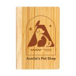 A bamboo notebook featuring a pet-themed design and a logo, showcasing a warm, natural wood color.
