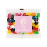 A cello bag filled with assorted color mini jelly beans, including red, yellow, green, and black candies.